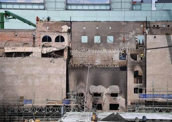 Workmen remove bricks fire damaged beyond reuse as they dismantle the Glasgow School of Art Mackintosh building. Picture: Jeff J Mitchell/Getty Images