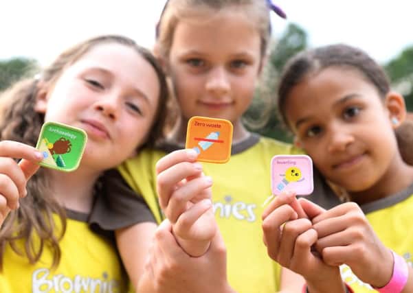 Girl Guides show off their badges (Picture: Doug Peters/PA)