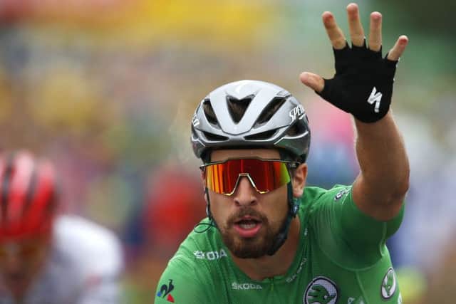 Slovakia's Peter Sagan raises his hand as he crosses the line in Valence. Picture: Peter Dejong/AP