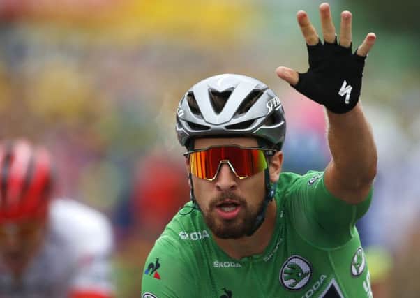 Slovakia's Peter Sagan raises his hand as he crosses the line in Valence. Picture: Peter Dejong/AP