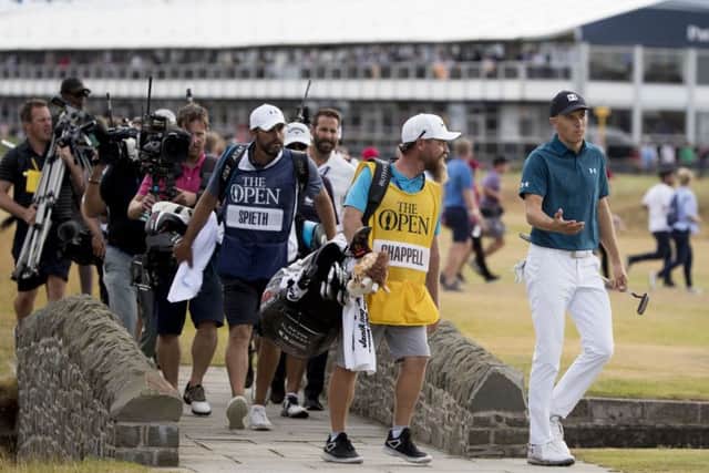 Jordan Spieth, right, crosses the Barry Burn to make his way to the 18th green. Photograph: Kenny Smith/SNS