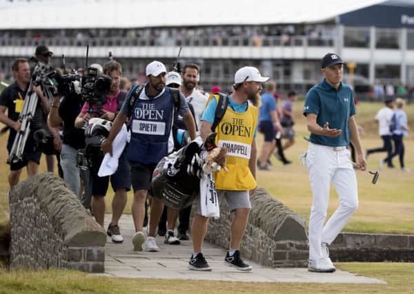 Jordan Spieth, right, crosses the Barry Burn to make his way to the 18th green. Photograph: Kenny Smith/SNS
