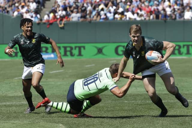 South Africa's Dylan Sage, right, tries to evade Scotland's Gavin Lowe during the Rugby Sevens World Cup in San Francisco. Picture: Jeff Chiu/AP