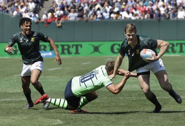 South Africa's Dylan Sage, right, tries to evade Scotland's Gavin Lowe during the Rugby Sevens World Cup in San Francisco. Picture: Jeff Chiu/AP