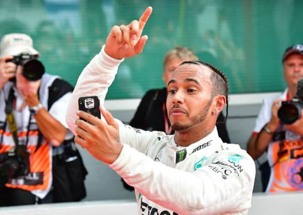 Lewis Hamilton takes a selfie  as he celebrates winning the German Grand Prix at Hockenheim yesterday. Picture: AFP/Getty