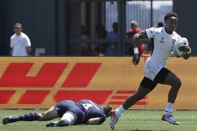 Carlin Isles of the US runs past Scotland's Robbie Fergusson to score at the Rugby World Cup Sevens in San Francisco. Picture: Jeff Chiu/AP