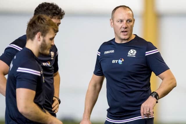 John Dalziel, right, puts the players through their paces. Picture: SNS