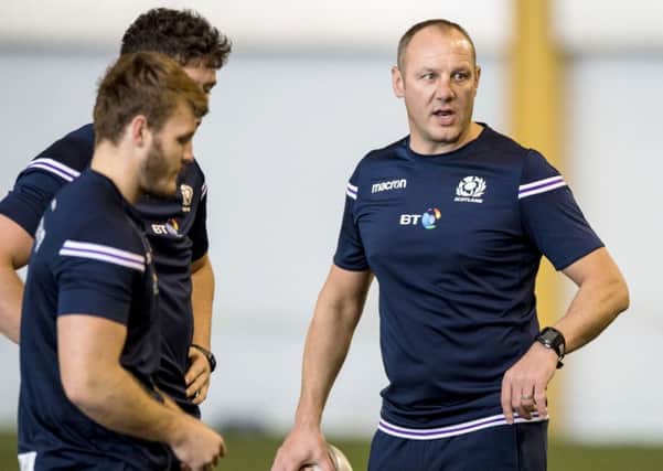 John Dalziel, right, puts the players through their paces. Picture: SNS
