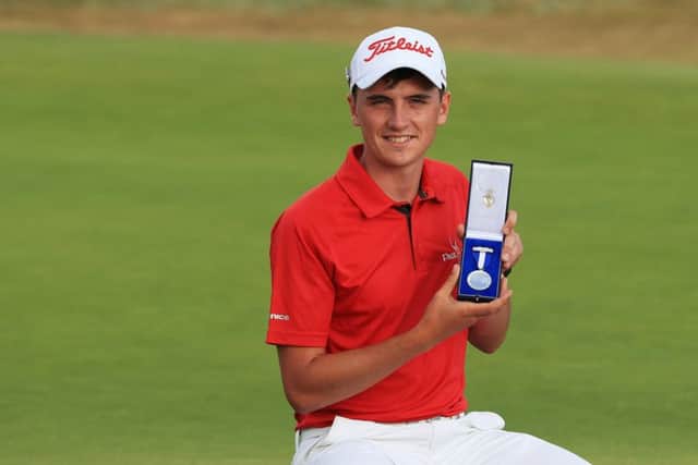 Sam Locke oholds the Silver Medal on the 18th green at Carnoustie. Picture: Getty Images