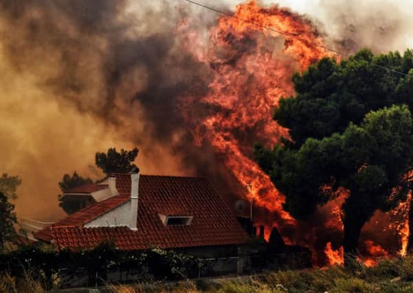 High winds spread the fires quickly, engulfing homes and cars, with thick smoke seen for miles. Firefighters battled the blazes as others offered supplies to those affected. Picture: Getty