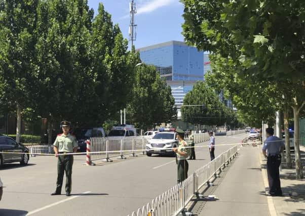 The road to the embassy is sealed off. (AP Photo/Andy Wong)
