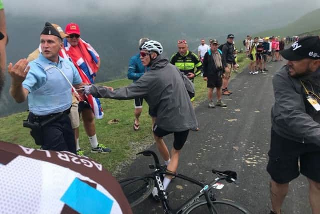 Chris Froome confronts the gendarme after being grabbed. Picture: PA/Albert Secall