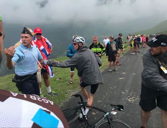 Chris Froome confronts the gendarme after being grabbed. Picture: PA/Albert Secall