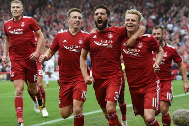 Gary Mackay-Steven (right) celebrates with his team-mates after opening the scoring. Picture: SNS