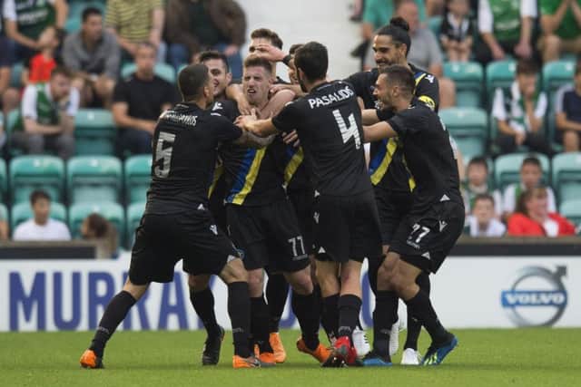 Georgios Kyriakopoulos (centre) is mobbed by his Asteras Tripolis team-mates after making it 2-0 to the visitors. Picture: SNS