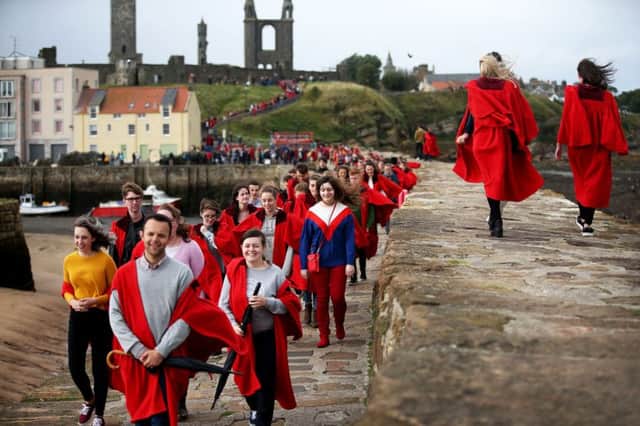 New students at the University of St Andrews take part in the traditional Pier Walk along the harbour walls of St Andrews before the start of the new academic year