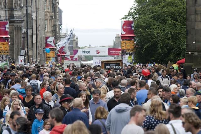 Crowds gather to watch street performers on the Royal Mile. Picture: Alistair Linford