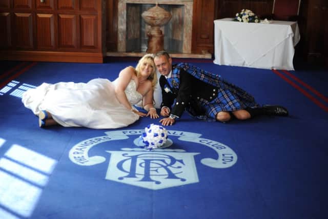 The completely blue and white wedding, the colours of the Glasgow club, saw Amanda, 36, walk down the aisle in royal blue shoes and Tommy, 43, in a Ranger's kilt. Picture; Centre Press