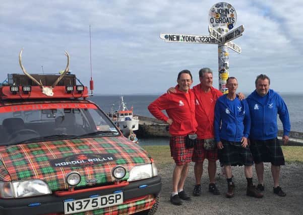 Jo Williamson (left) and Gordon Blair (far right) at John O' Groats with two friends and a Mongolia-bound tartan Fiesta.