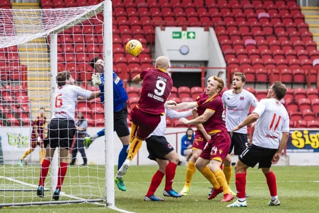 Motherwell's Curtis Main bundles home the leveller. Pic: SNS/Roddy Scott