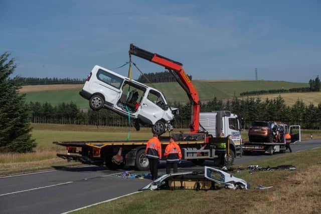 A minibus is removed from the A96 between Huntly and Keith in Moray where a five people have died and five more were injured after a crash between a minibus and a car. Picture: Michal Wachucik/PA Wire
