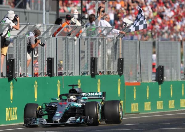 Lewis Hamilton crosses the finishing line to win the Hungarian Grand Prix. Picture: AFP/Getty.