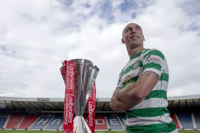 Celtic captain Scott Brown with the Premiership trophy at Hampden yesterday. Picture: PA