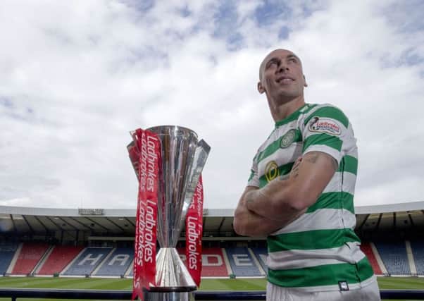 Celtic captain Scott Brown with the Premiership trophy at Hampden yesterday. Picture: PA