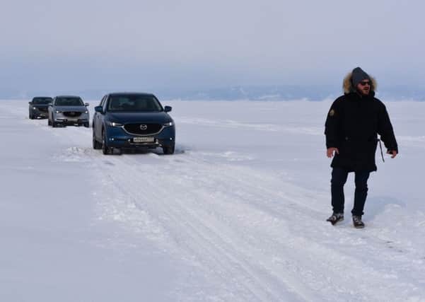 The convoy of cars crosses the thick Siberian ice Picture: Lisa Young