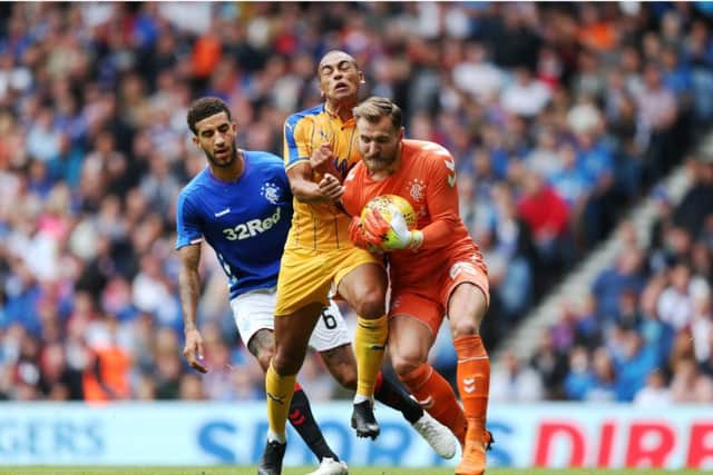 Rangers goalkeeper Jak Alnwick smothers the ball during Sundays friendly victory over Wigan at Ibrox. Picture: PA.