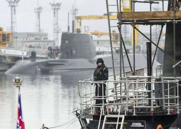 A member of the armed services on the deck of Vanguard-class submarine HMS Vigilant, one of the UK's four nuclear warhead-carrying submarines at HM Naval Base Clyde. Picture: Danny Lawson/PA Wire