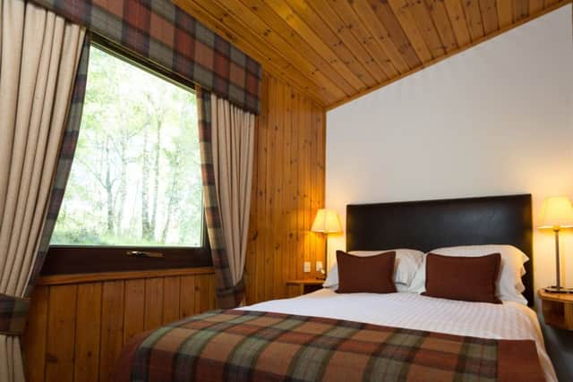 Picture: a double bedroom in a chalet at Macdonald Lochanhully Woodland Resort