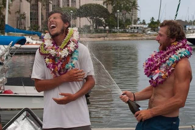 Michael Prendergast (centre) and his Uniting Nations team celebrating after arriving in Hawaii, as the 23-year-old Scot has become the youngest person to row the Pacific Ocean. Picture: Ellen Hoke/Great Pacific Race/PA Wire.