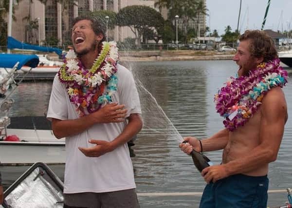 Michael Prendergast (centre) and his Uniting Nations team celebrating after arriving in Hawaii, as the 23-year-old Scot has become the youngest person to row the Pacific Ocean. Picture: Ellen Hoke/Great Pacific Race/PA Wire.