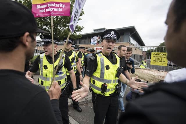 Police ask demonstrators to move back from the gates to the Home Office in Brand Street, Glasgow. Picture: John Devlin/TSPL