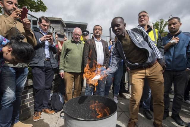 Protest and burning of copies of eviction letters outside the UK Home Office and SERCO's offices at 200 Brand Street. Picture; John Devlin