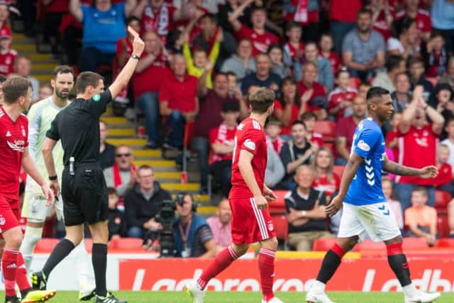 Alfredo Morelos is given his marching orders by referee Kevin Clancy. Picture: PA