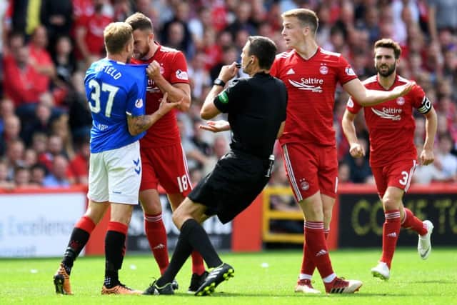 Aberdeen's Mikey Devlin (right) comes face-to-face with Scott Arfield. Picture: SNS