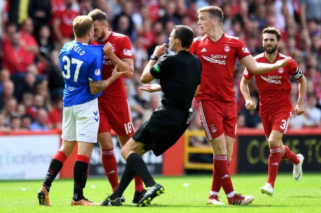 Aberdeen's Mikey Devlin (right) comes face-to-face with Scott Arfield. Picture: SNS