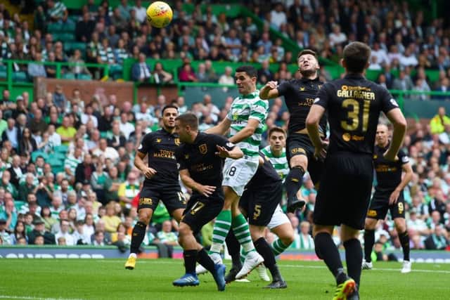 Tom Rogic rises to head home Celtics first goal as they opened their title defence with a 3-1 victory over Livingston on Saturday. Picture: SNS.