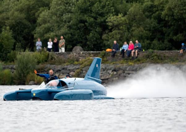 Pilot Ted Walsh fires up the jet engine of Donald Campbell's iconic Bluebird as it propels on the waters of Loch Fad for the first time for 50 years. Picture: Christopher Furlong/Getty Images.