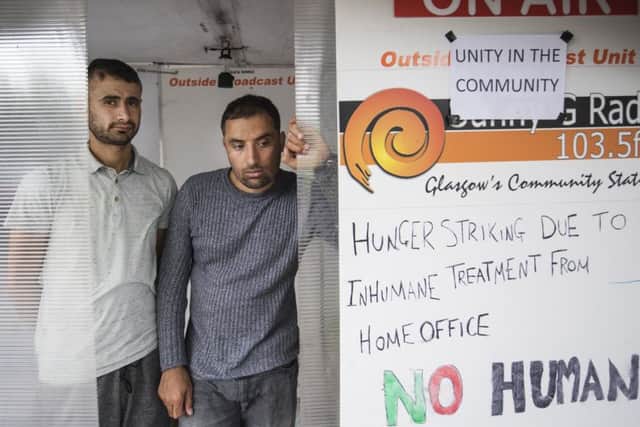 Two refugees began a hunger strike outside the Home Office base in Glasgow after being placed at risk of eviction from their homes in the city, while hundreds took to the streets in protest. Picture: John Devlin
