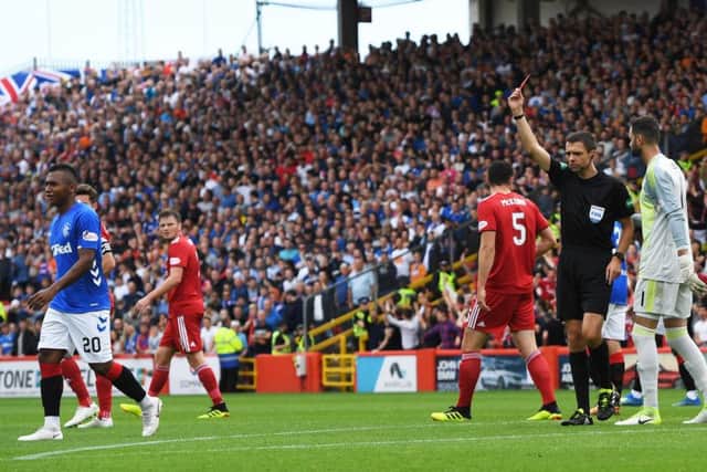 Kevin Clancy shows Rangers striker Alfredo Morelos a red card for an off the ball incident with Scott McKenna. Picture: SNS/Craig Williamson