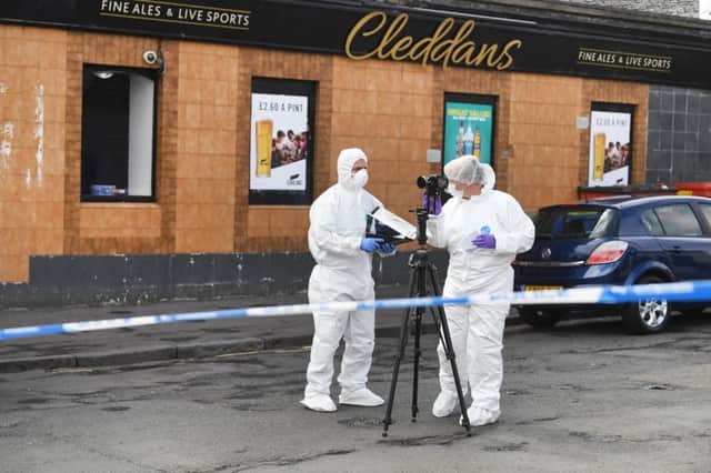 Forensic officers at the scene of the death in Clydebank. Picture: John Devlin