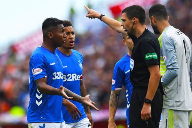 Alfredo Morelos is sent packing by referee Kevin Clancy. Picture: SNS