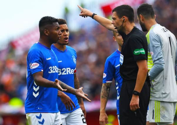 Alfredo Morelos is sent packing by referee Kevin Clancy. Picture: SNS