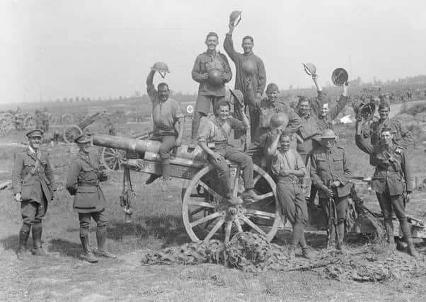 Following the capture of Grevillers by the New Zealand Division, Men of the Royal Garrison Artillery pose beside one of the 4.2 inch guns of a captured battery at Grevillers, 25 August 1918. Note the camouflage netting on the ground, which was designed to prevent the guns from being spotted from the air. Â© IWM (Q 11243)