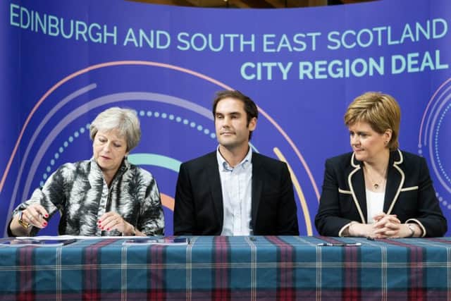 (L-R) Prime Minister Theresa May, City of Edinburgh Council leader Adam McVey and First Minister Nicola Sturgeon sign the Edinburgh and South East Scotland City Region Deal. Picture: Jane Barlow/PA Wire