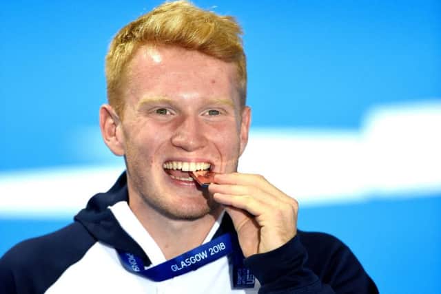 Great Britain's James Heatly celebrates with his bronze medal in the men's 1m springboard final. Picture: Ian Rutherford/PA