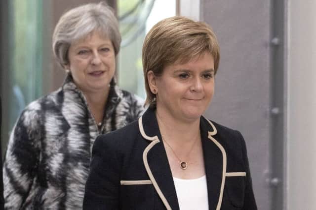 Britain's Prime Minister Theresa May (L) and Scotland's First Minister Nicola Sturgeon arrive for the signing the Edinburgh and South East Scotland City Region Deal at the University of Edinburgh. Picture: Jane Barlow/Getty